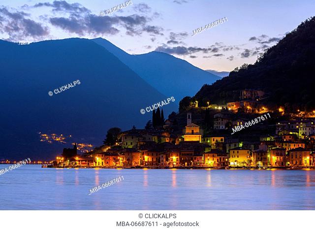 Peschiera Maraglio shortly after sunset, the lights of the small village of Montisola, the lake island more 'big in Europe, in the province of Brescia