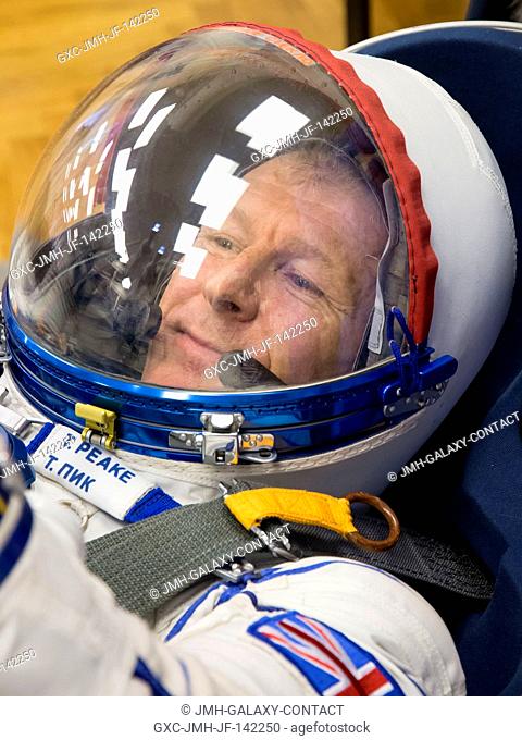 In the Integration Facility at the Baikonur Cosmodrome in Kazakhstan, Expedition 46-47 crewmember Tim Peake of the European Space Agency flashes a smile as he...