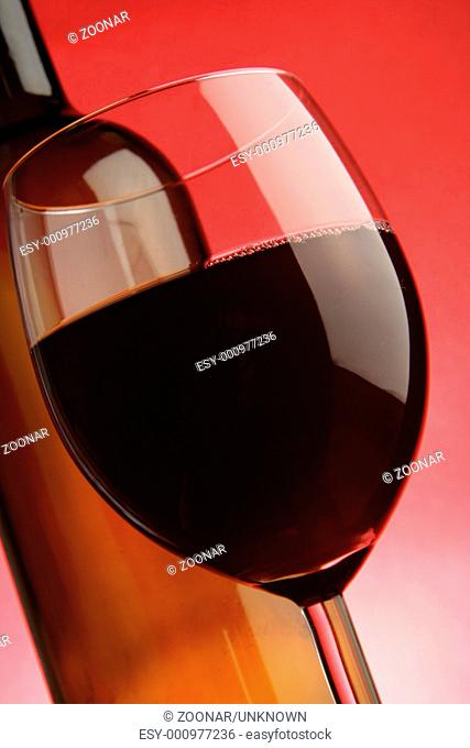 Glass and bottle of red wine close-up