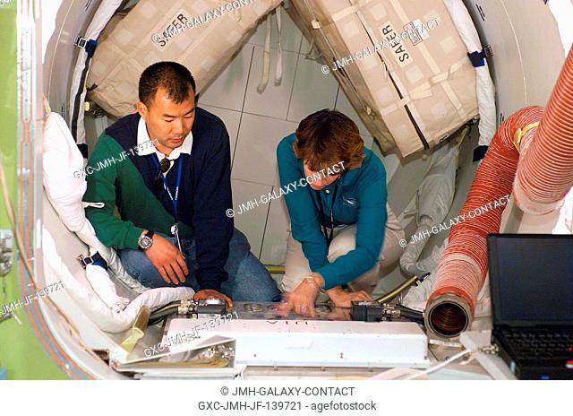 Astronauts Eileen M. Collins (right) and Soichi Noguchi, STS-114 mission commander and mission specialist, respectively, participate in mission training in the...
