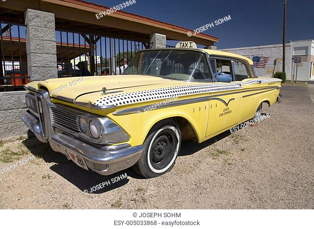 1958 yellow Edsel with dummy driver parked in Seligman Arizona off Route 66