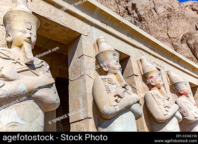 Close-up of the Osirian form colossi statues of Hatshepsut, the fifth pharaoh of the Eighteenth Dynasty, found on the second terrace portico of the Mortuary...