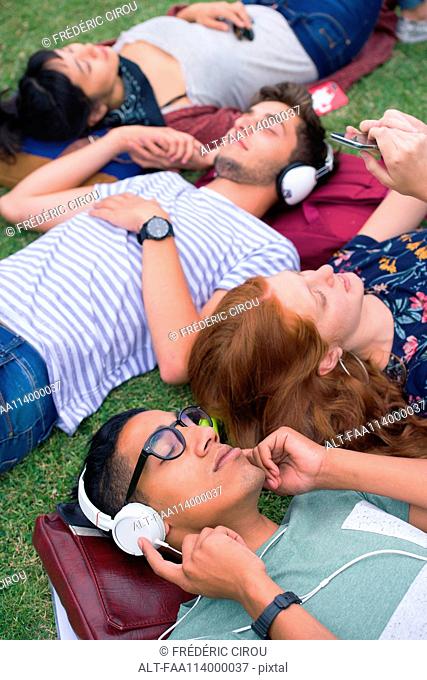College students relaxing on grass between classes