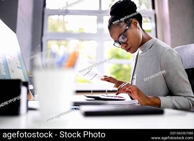 African American Accountant Or Auditor With Calculator