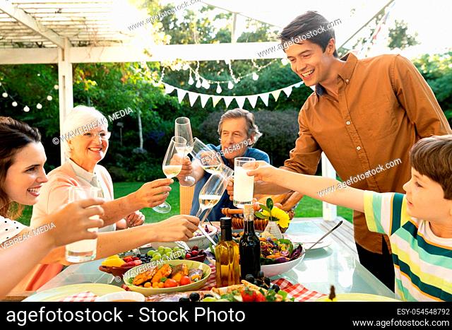 Family eating outside together in summer