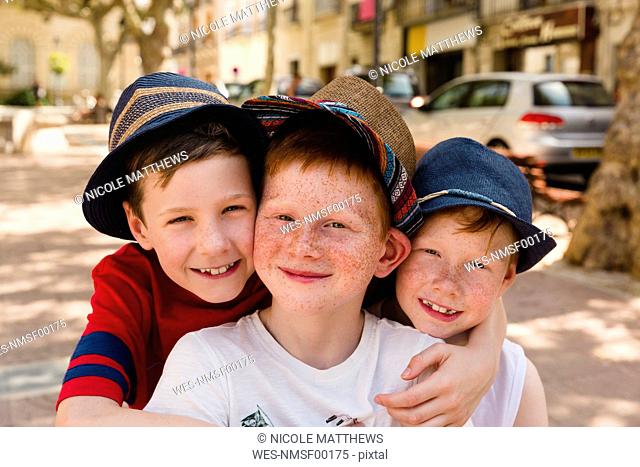 Group picture of three happy boys on holiday