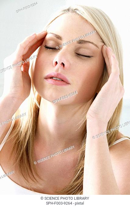 Headache. Woman rubbing her temples