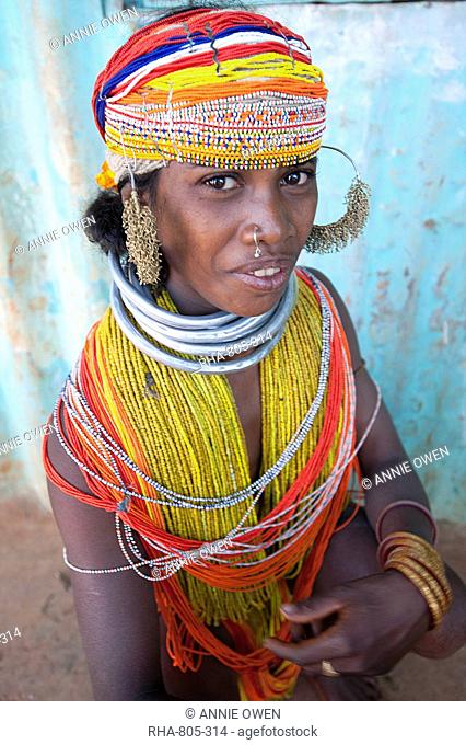 Bonda tribeswoman wearing traditional bead costume with beaded cap, large earrings and metal necklaces at weekly market, Rayagader, Orissa, India, Asia