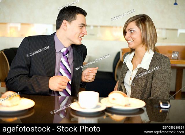 Man and Woman at Cofe Table. Short Depth of Focus (On Their Faces)