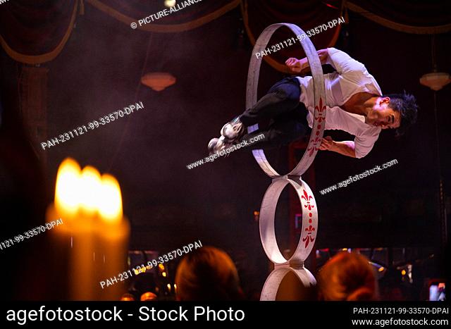 21 November 2023, Bavaria, Munich: An artist jumps through hoops on stage during the anniversary show to celebrate ""20 years of Teatro""