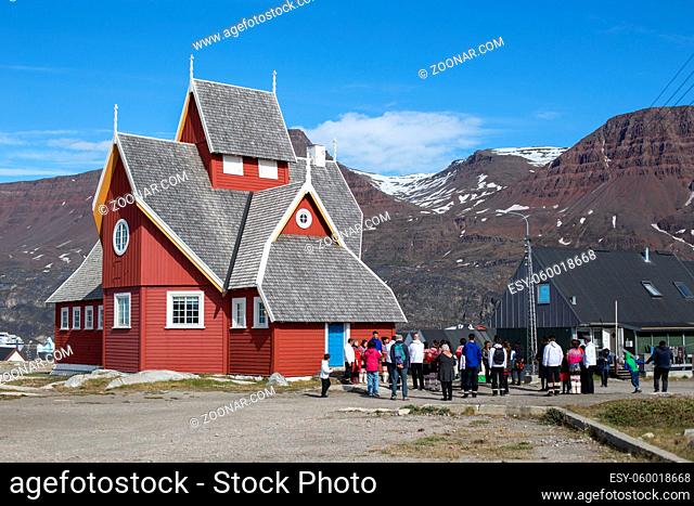 Qeqertarsuaq, Greenland - July 4, 2018: People in front of the church