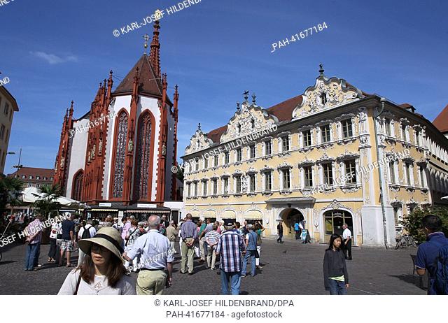 Tourists stand in front of the St. Mary's Chapel (L) and the Baroque Falkenhaus (lit. Falcons house) in Wuerzburg, Germany, 11 August 2013