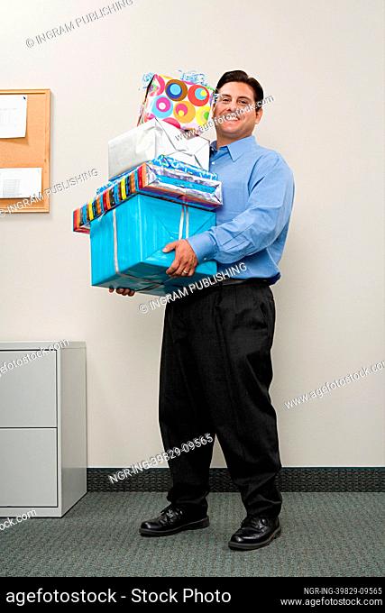 Man carrying pile of presents