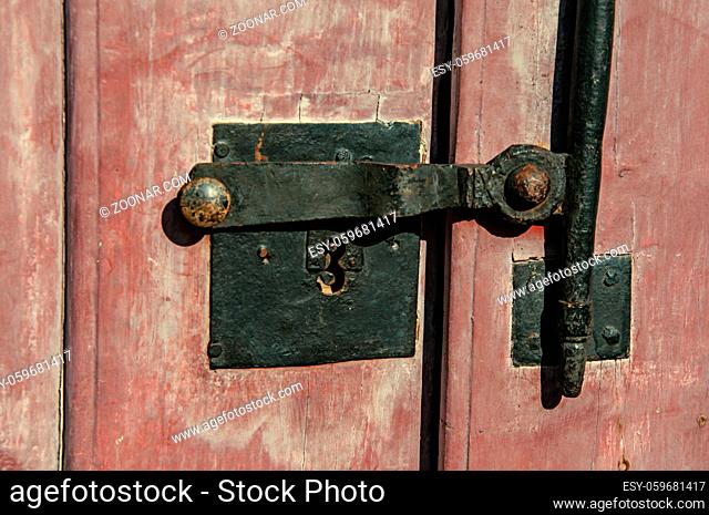 Close-up of iron bolt and lock on wooden door in Paraty, an amazing and historic town totally preserved in the coast of the Rio de Janeiro State