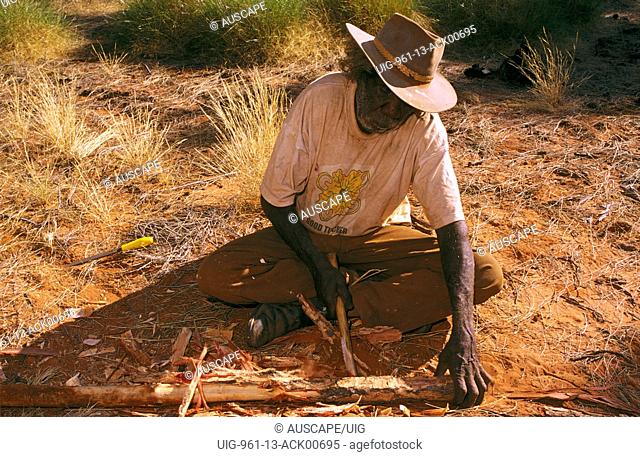 Balgo artist Making spear from Desert oak wood Great Sandy Desert, Western Australia