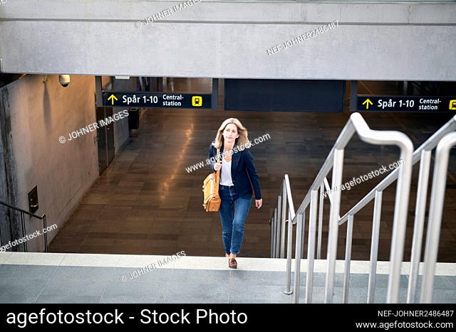 Woman walking upstairs from train station