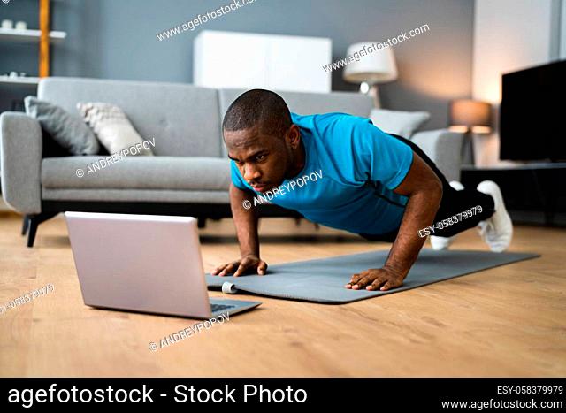 African American Man Doing Online Fitness Pushup Workout At Home