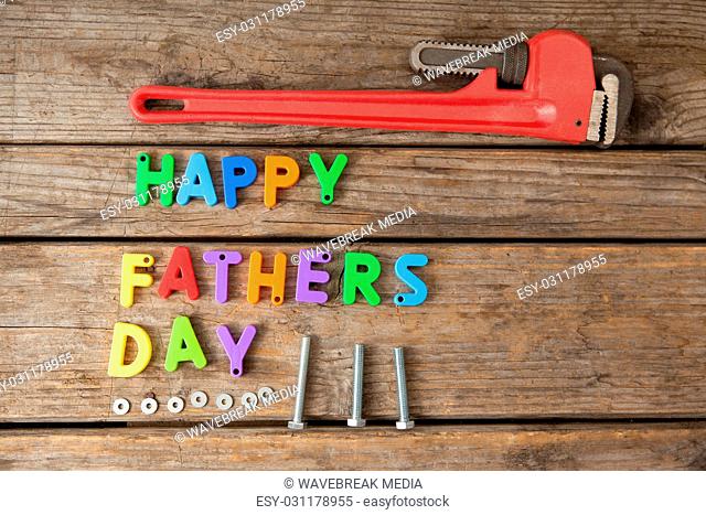 Happy fathers day blocks and handtools on wooden plank