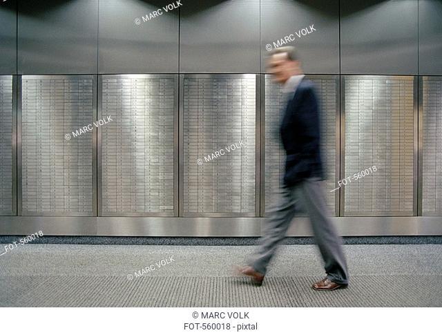 A man walking past safety deposit boxes