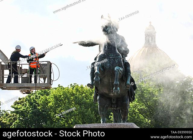 RUSSIA, ST PETERSBURG - MAY 26, 2023: Utility workers wash the Bronze Horseman, an equestrian statue of Peter the Great by French sculptor Etienne Maurice...