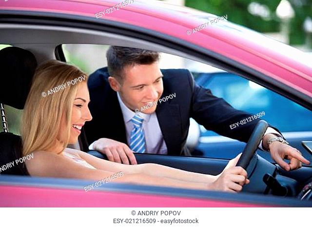Salesman Showing Car To Customer