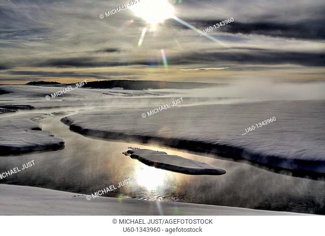 Steam and sun surround Alum Creek in the Hayden Valley at Yellowstone National Park, Wyoming