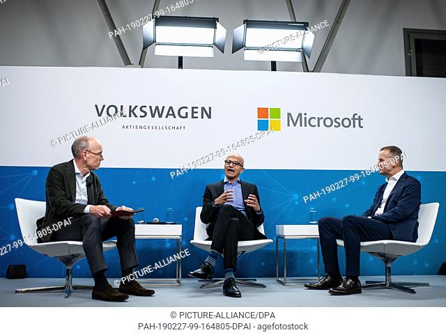 27 February 2019, Berlin: Herbert Diess (r), Chairman of the Board of Management of Volkswagen AG, and Satya Nadella (M), CEO of Microsoft