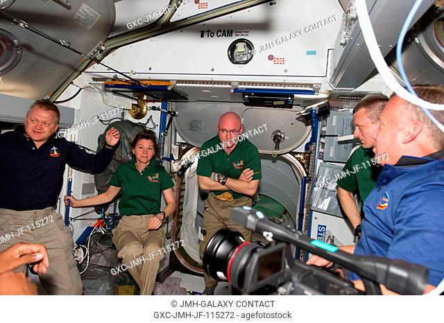 STS-133 and Expedition 26 crew members are pictured in the Harmony node of the International Space Station shortly after space shuttle Discovery and the space...