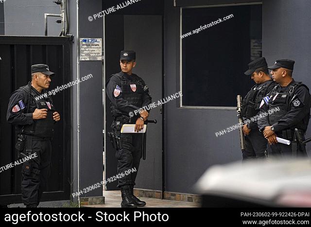 02 June 2023, El Salvador, San Salvador: Police officers are on duty at the ""Santa Lucia"" drugstore owned by ex-president Cristiani