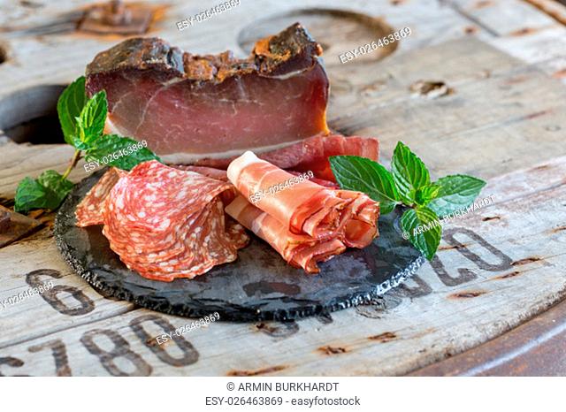 a selection of fine ham on a wooden ground