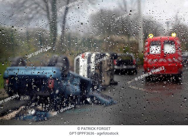 ROAD ACCIDENT ON A RAINY DAY ON A WET ROAD INVOLVING SEVERAL VEHICLES, FIRE DEPARTMENT AMBULANCE PRESENT AT THE SITE, ALENCON, ORNE 61, FRANCE