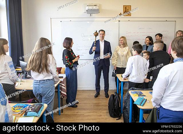 Prime Minister Alexander De Croo holds a scepter with floral decoration during a visit of Belgian Prime Minister De Croo to a Ukrainian school on the occasion...