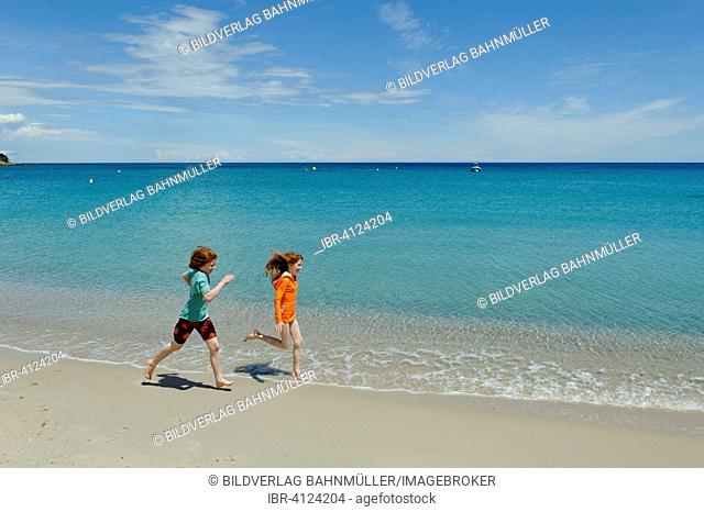 Children running on beach of Favone, east coast, Corsica, France