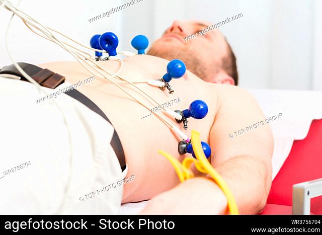 Male patient having ECG electrocardiogram in hospital