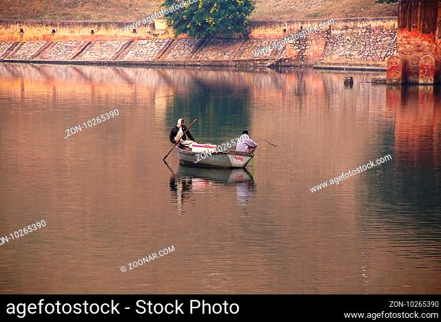Local men fishing in Maota Lake near Amber Fort, Rajasthan, India. Amber Fort is the main tourist attraction in the Jaipur area