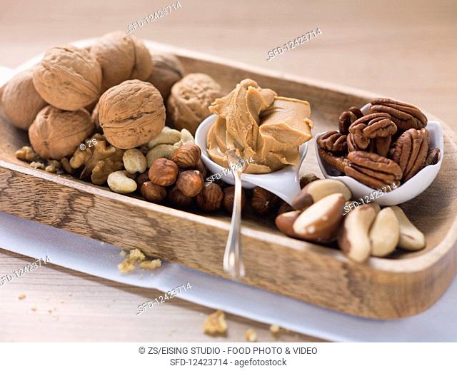A selection of nuts and a spoonful of peanut butter