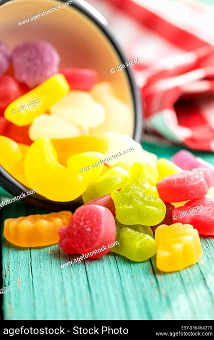 Colorful fruity jelly candies on green table
