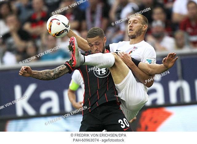 Frankfurt's Luc Castaignos (l) and Augsburg's Ragnar Klavan (r) battle for the ball during the game between Eintracht Frankfurt and FC Augsburg in the...