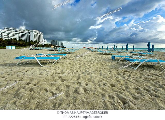 Sun loungers on the beach at South Beach, Miami, Florida, USA