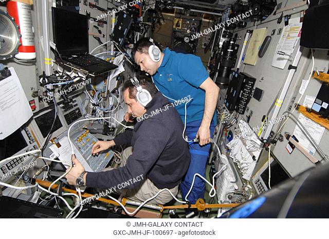Russian cosmonauts Anton Shkaplerov (left) and Oleg Kononenko, both Expedition 30 flight engineers, monitor data at the manual TORU docking system controls in...