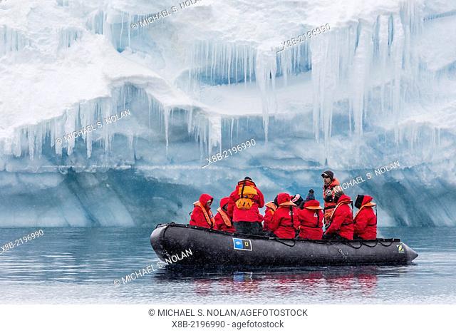 Lindblad Expeditions guests in a Zodiac approach a glacial face at Brown Bluff, Weddell Sea, Antarctica