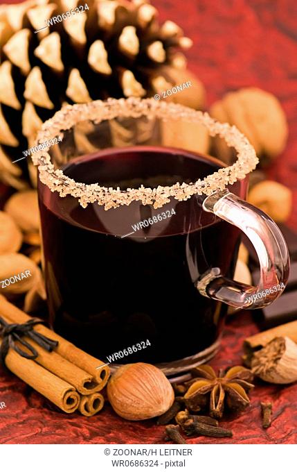 Hot wine punch with Christmas decoration as closeup
