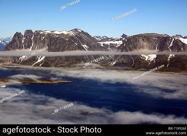 Iceberg, ice and islands, in a fjord, aerial view, rough, snow-covered rough mountain landscape, aerial view, South Greenland, Nanortalik, North America