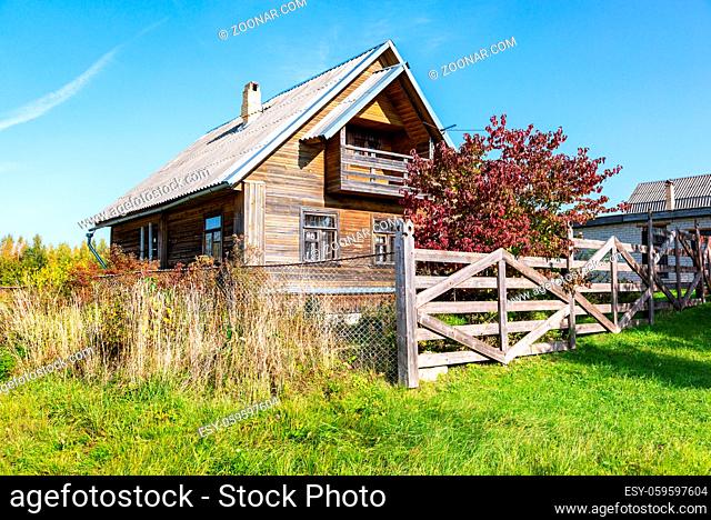 Traditional rural wooden house in russian village in summer sunny day. Novgorod region, Russia