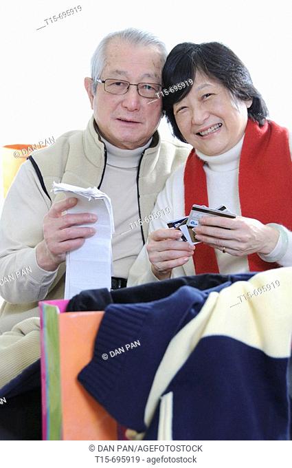 Senior asian couple shopping according to their budget