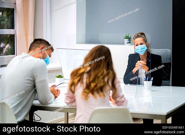 Young Family Couple Meeting Consultant Or Lawyer With Face Masks