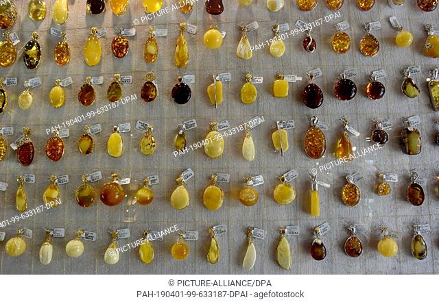 08 July 2018, Poland, Danzig: Pendants made of amber in an amber shop on the banks of the Motlau in Gdansk. The armoury was built between 1600 and 1609