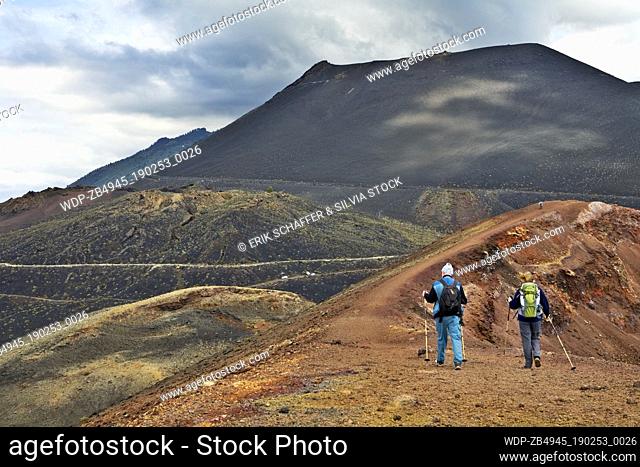 Walkers on rim of Teneguia volcano with San Antonio volcano in background