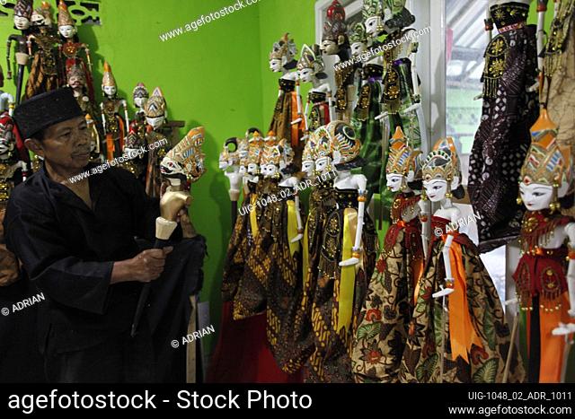 A craftsman Entang Sutisna (73) showing a 'wayang golek' or golek puppet from lame wood (Alstonia scholaris) at the Media Art and Handicraft workshop