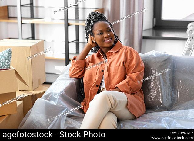 happy woman with boxes moving to new home